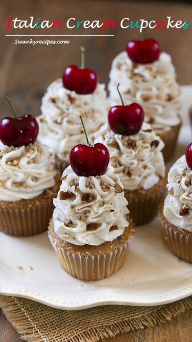 Italian Cream Cake Cupcakes 1 Italian Cream Cupcakes - Light, airy and rich vanilla buttermilk and almond cupcakes blended with sweetened coconut and pecans. Topped with the ultimate cream cheese and buttercream frosting with cherries and pecans. These cupcakes will quickly become a family favorite. Serve for the holidays or during summer months when fresh cherries are readily available.