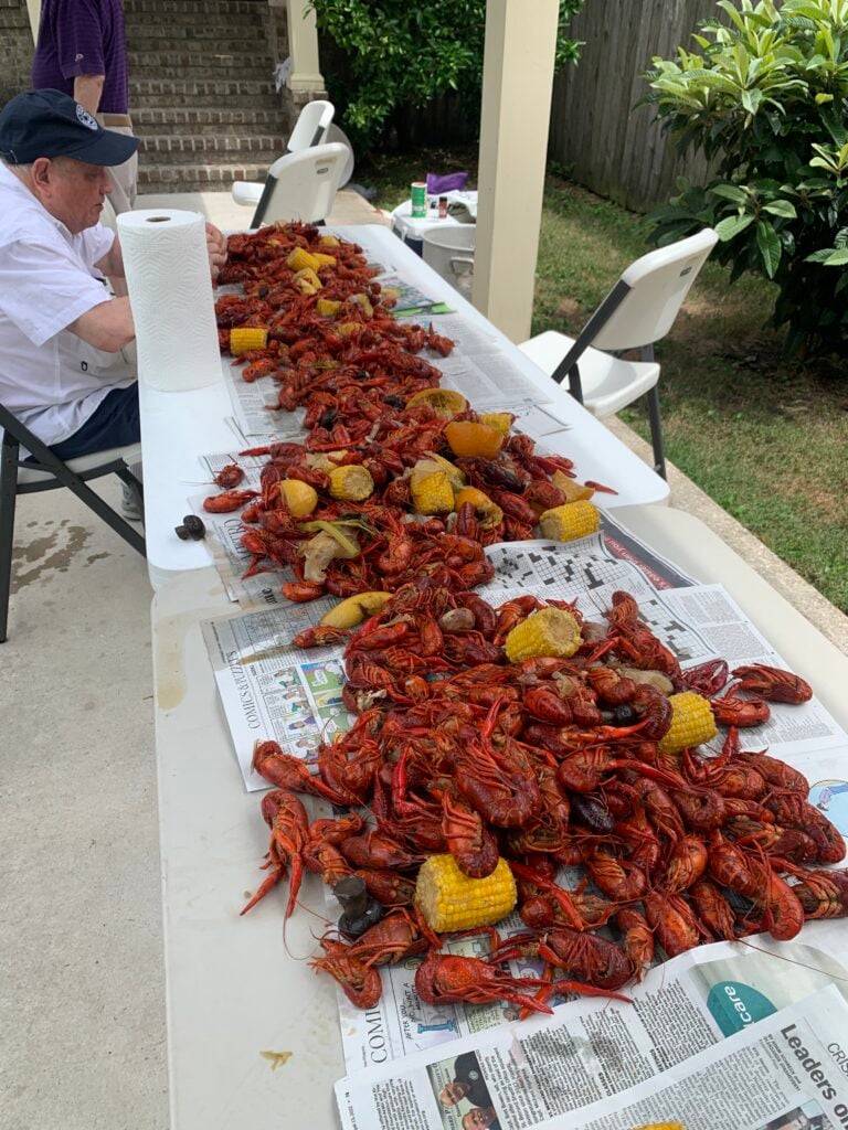 20 Must-Try Foods and Activities in New Orleans 4 The bright red crawfish are heaped in the center of the table, surrounded by sides of corn on the cob and potatoes, all seasoned with spicy, Cajun flavors.