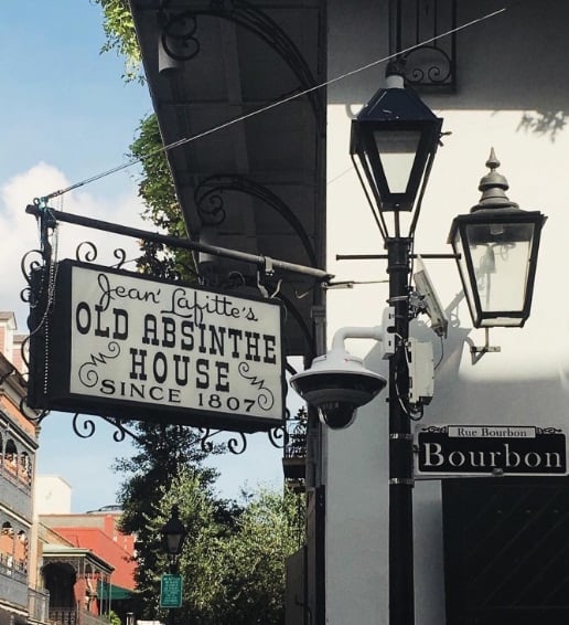20 Must-Try Foods and Activities in New Orleans 21 Old Absinthe House sign outside. This iconic establishment captures the essence of historical New Orleans charm and its legendary drinking culture.