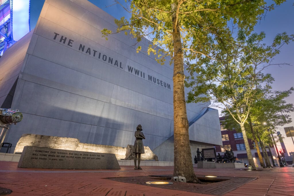 20 Must-Try Foods and Activities in New Orleans 27 Exterior view of the National WWII Museum in New Orleans, featuring a modern architectural design with multiple geometric buildings made of glass and steel.